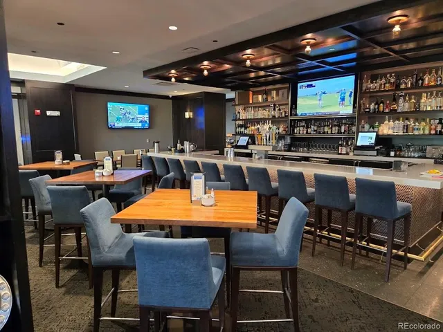 a view of a house with pool and chairs