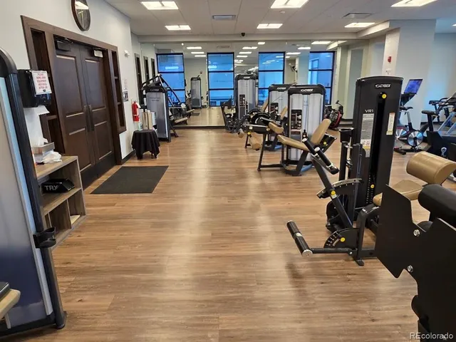 a view of a patio with a table and chairs under an umbrella