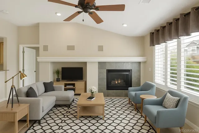 a view of a livingroom with a fireplace and a ceiling fan