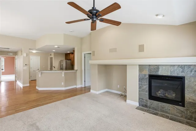 a kitchen with refrigerator and breakfast area