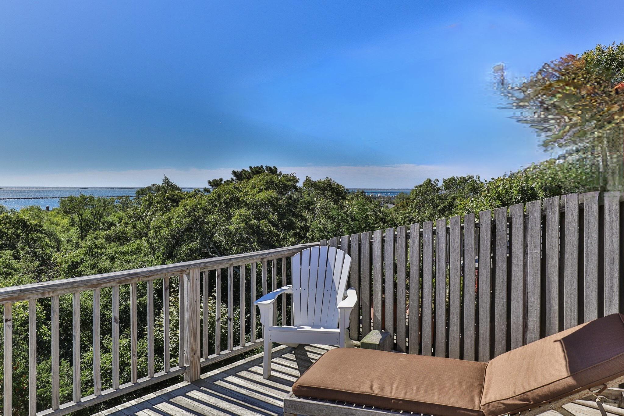 4 Willow Drive, Unit 9 Provincetown, MA 02657 - Photo 22 of 25 a balcony with wooden floor and fence