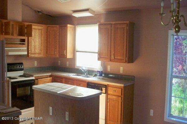 149 423rd Route Pocono Pines, PA 18350 - Photo 2 of 6 a kitchen with a sink stove and cabinets