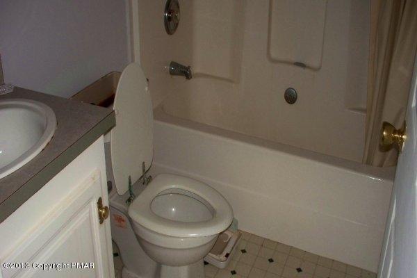 149 423rd Route Pocono Pines, PA 18350 - Photo 4 of 6 a bathroom with a granite countertop toilet and a sink