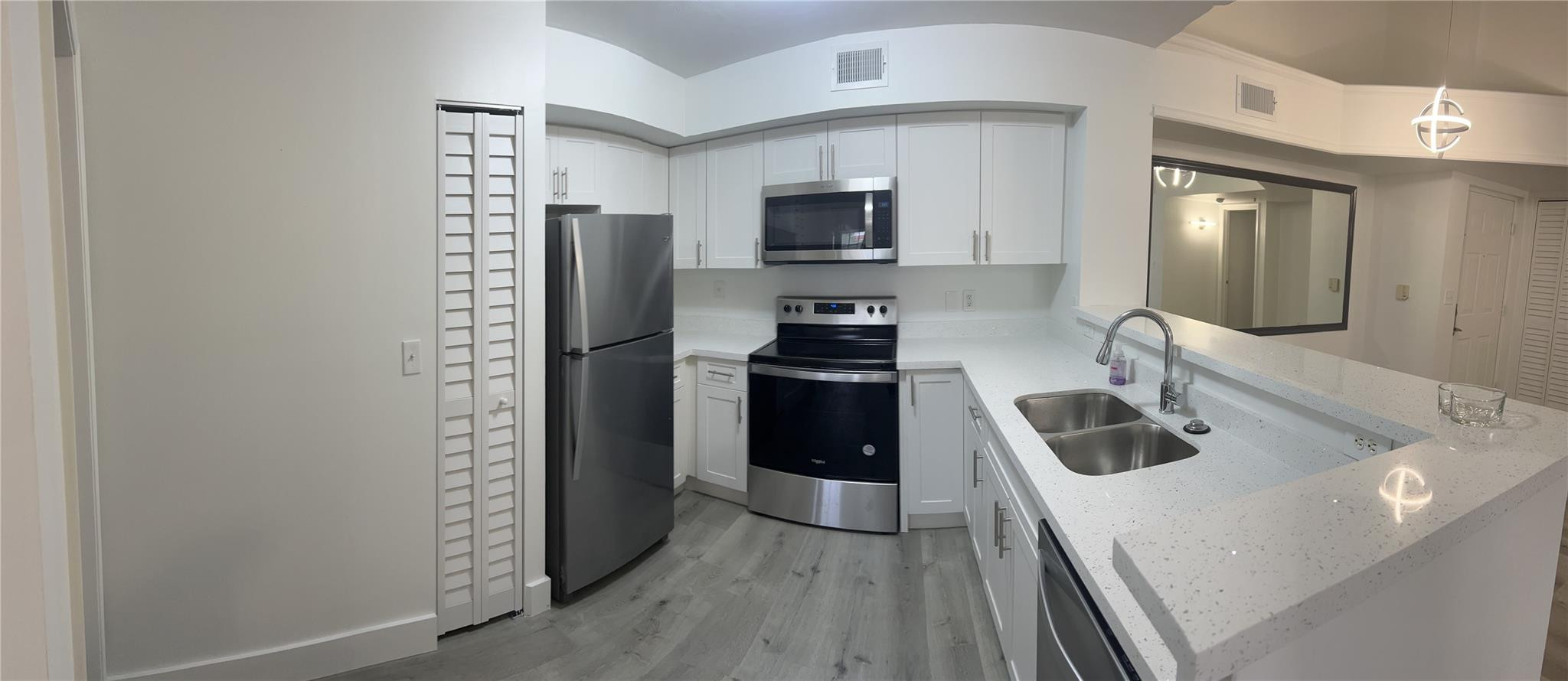 2113 Renaissance Boulevard, Unit 306 Miramar, FL 33025 - Photo 7 of 59 a kitchen with a refrigerator stove and sink