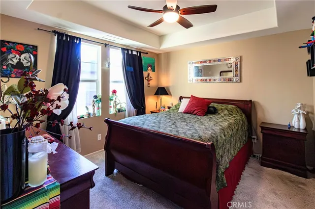 a bedroom with a bed a dresser next to a window