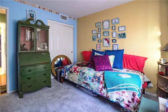 a bedroom with a bed and a painting on the wall