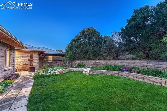 a living room with fireplace furniture and a large window