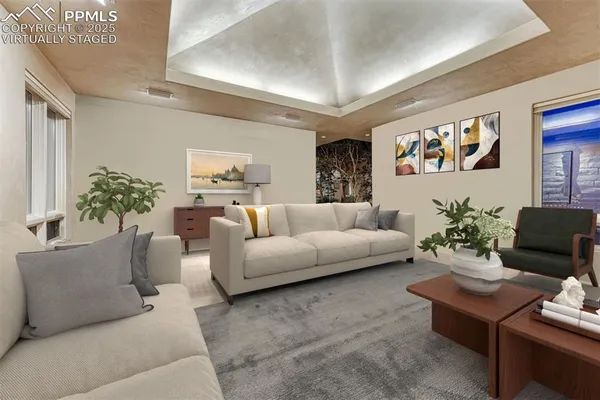 a living room with fireplace furniture and a large window