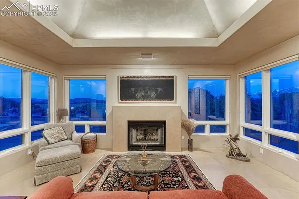 a dining room with furniture potted plants and wooden floor