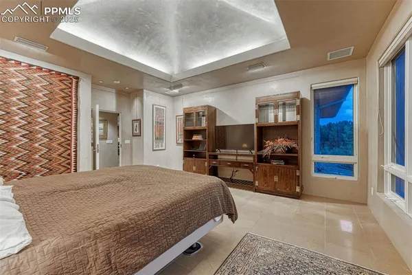 a bedroom with furniture and a window