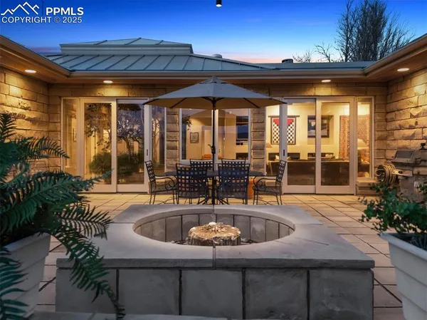 a view of a house with a yard and sitting area