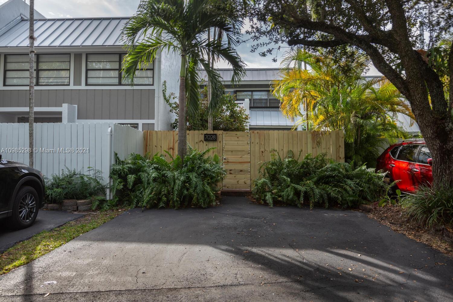 7028 Southwest 53rd Lane Miami, FL 33155 - Photo 1 of 27 a front view of a house with garden