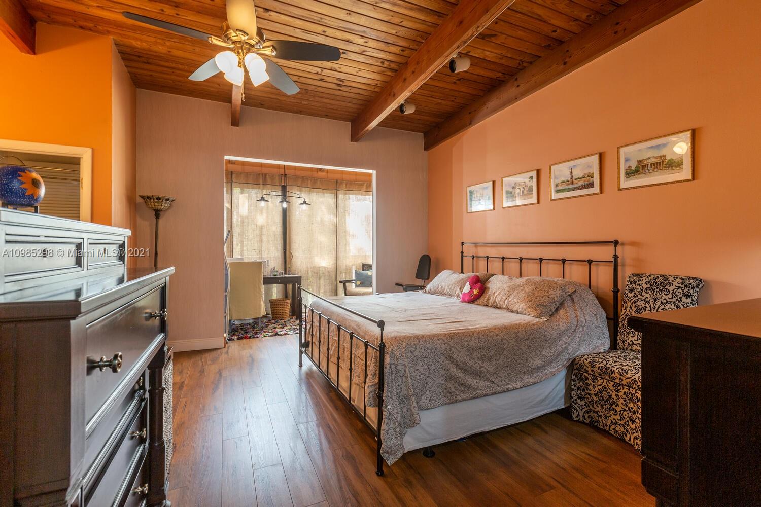 7028 Southwest 53rd Lane Miami, FL 33155 - Photo 11 of 27 a bedroom with a bed and a chandelier