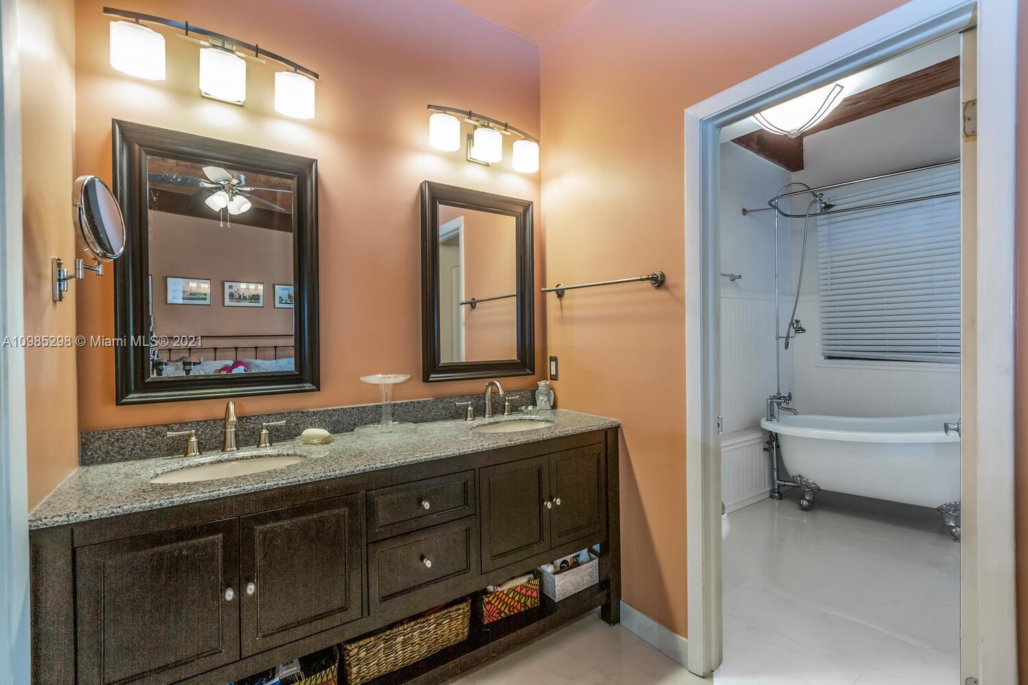 7028 Southwest 53rd Lane Miami, FL 33155 - Photo 13 of 27 a bathroom with a double vanity sink toilet mirror and bathtub