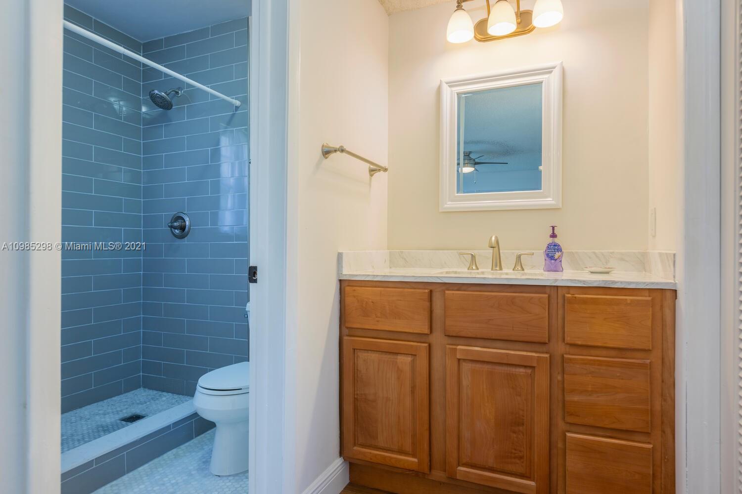 7028 Southwest 53rd Lane Miami, FL 33155 - Photo 15 of 27 a bathroom with a granite countertop sink toilet and shower