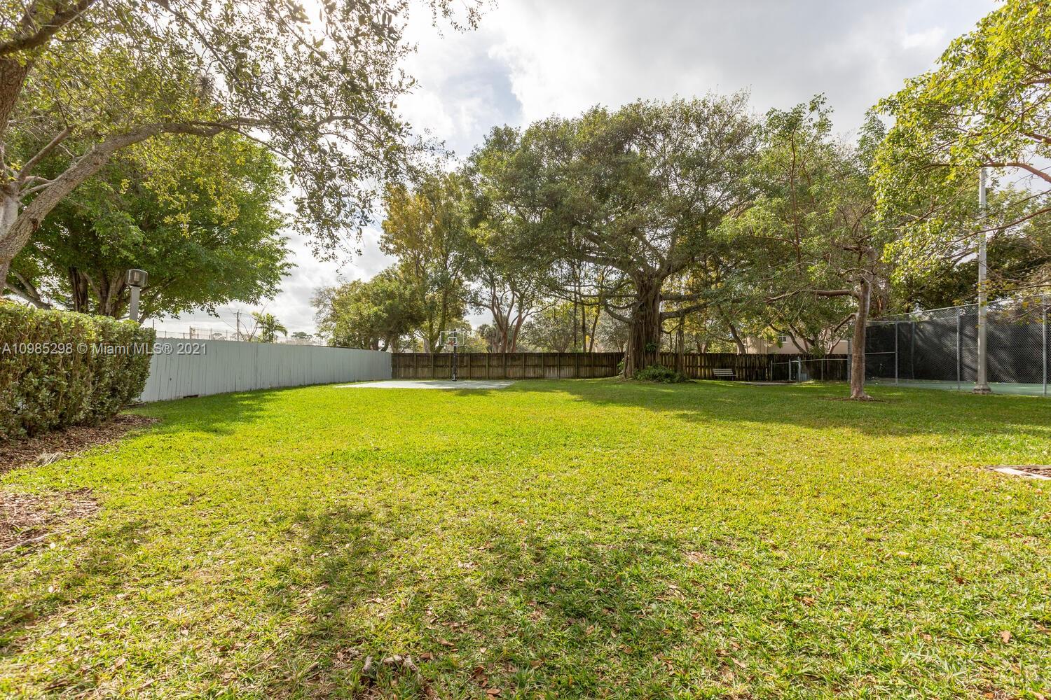 7028 Southwest 53rd Lane Miami, FL 33155 - Photo 21 of 27 a view of outdoor space with swimming pool and green space