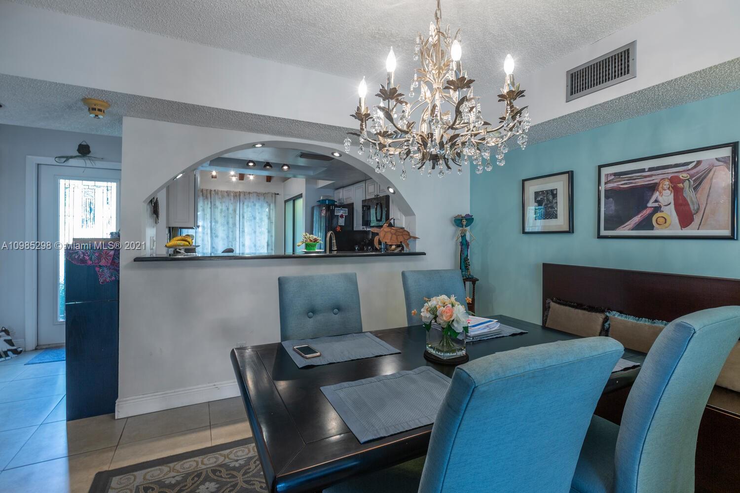 7028 Southwest 53rd Lane Miami, FL 33155 - Photo 4 of 27 a dining room with furniture and chandelier