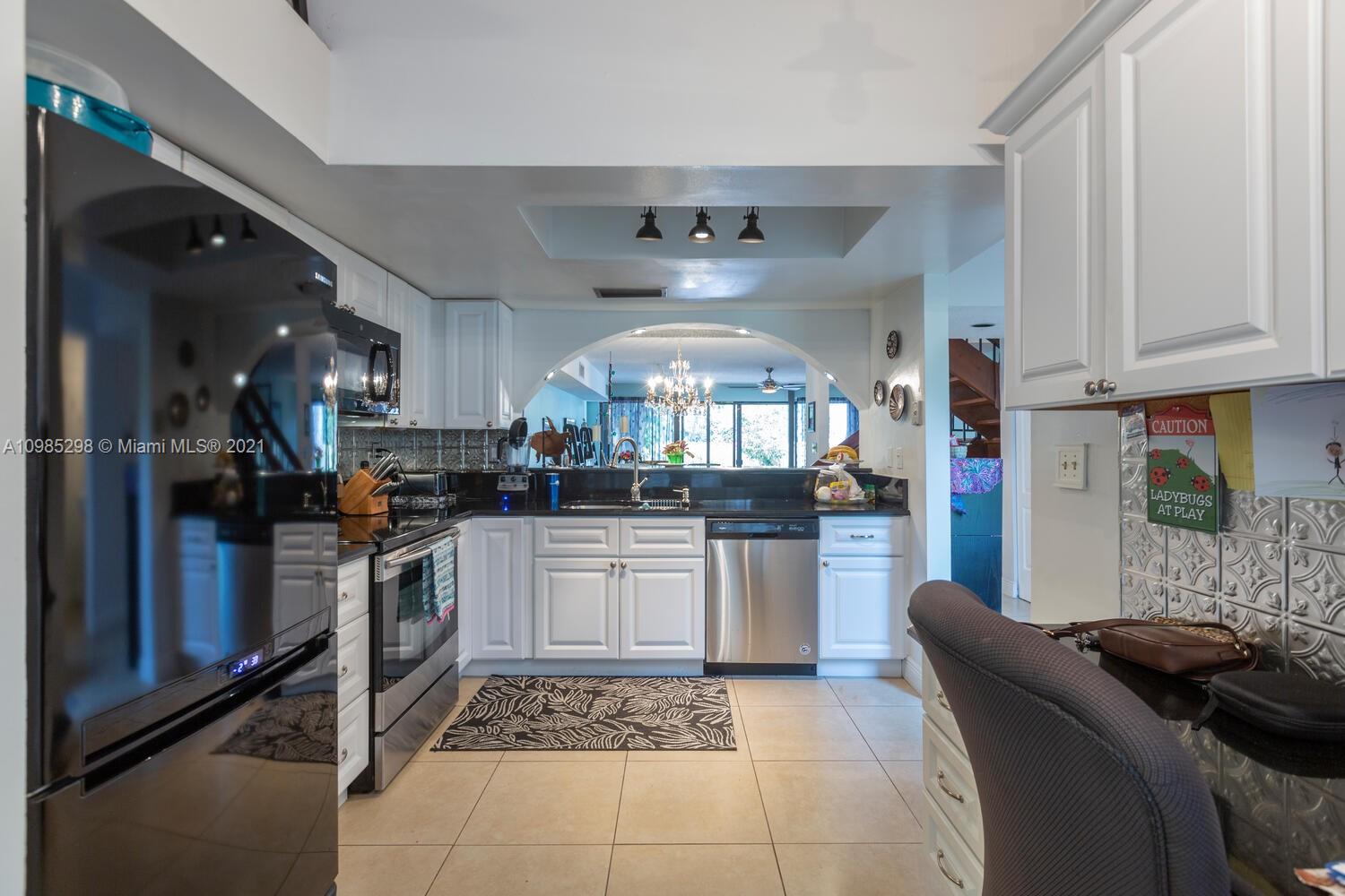 7028 Southwest 53rd Lane Miami, FL 33155 - Photo 6 of 27 a kitchen with stainless steel appliances granite countertop a stove a sink and a refrigerator
