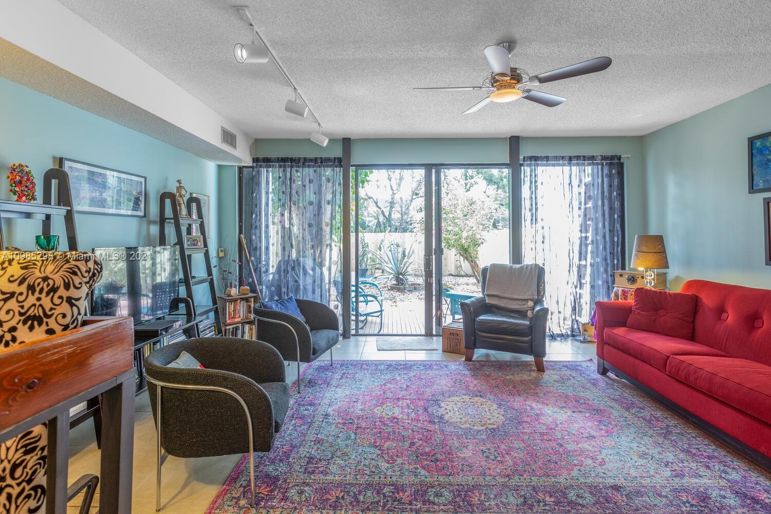 7028 Southwest 53rd Lane Miami, FL 33155 - Photo 7 of 27 a living room with furniture and a flat screen tv