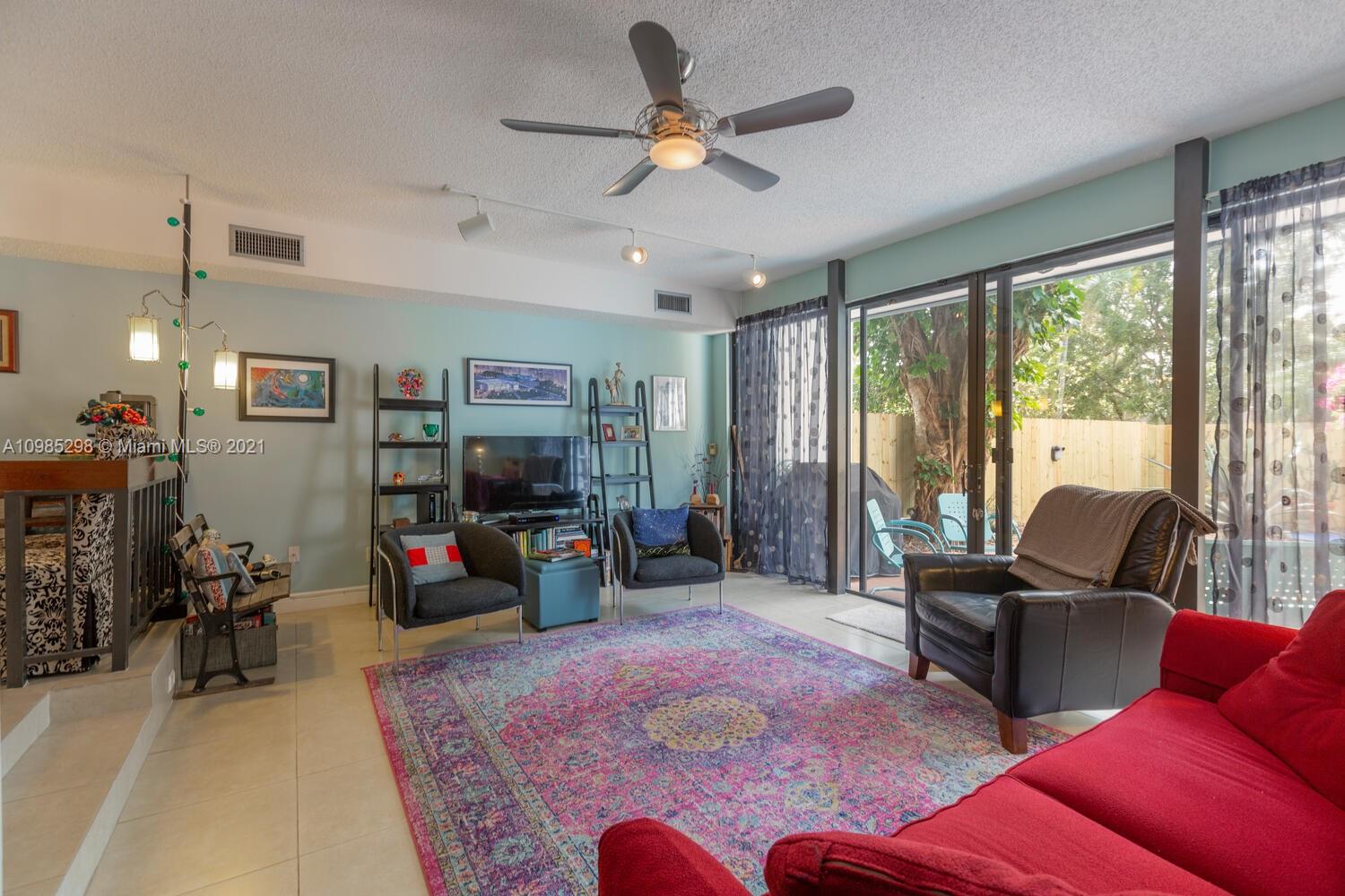 7028 Southwest 53rd Lane Miami, FL 33155 - Photo 8 of 27 a living room with furniture and a flat screen tv