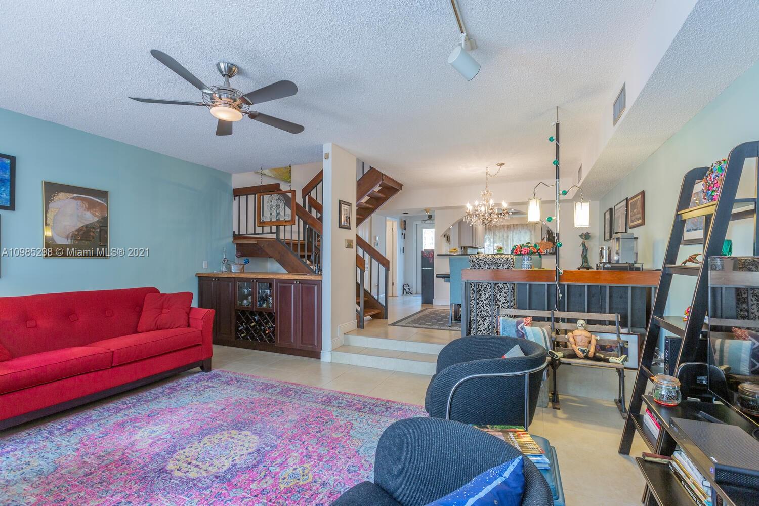 7028 Southwest 53rd Lane Miami, FL 33155 - Photo 9 of 27 a living room with furniture and a book shelf