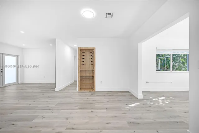 a kitchen with granite countertop white cabinets sink and stainless steel appliances