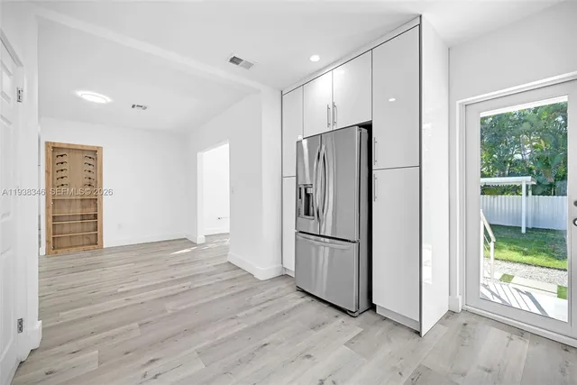 a dining room with furniture window and wooden floor