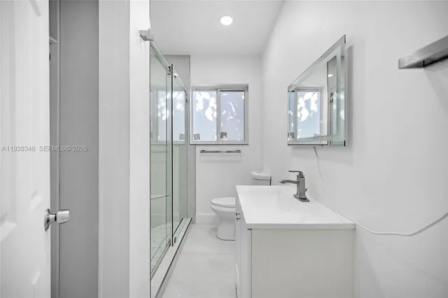 an empty room with wooden floor and window