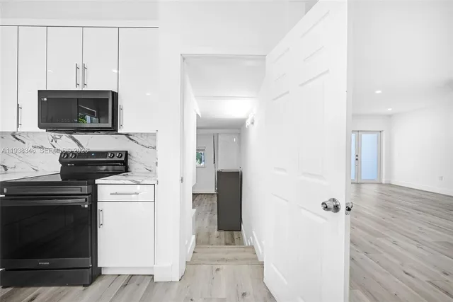 a bedroom with a bed and a potted plant on the wall