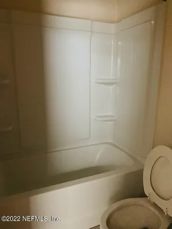 a bathroom with a shower and a toilet