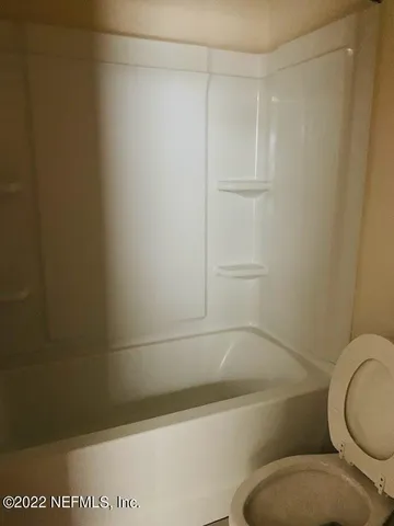 a bathroom with a shower and a toilet