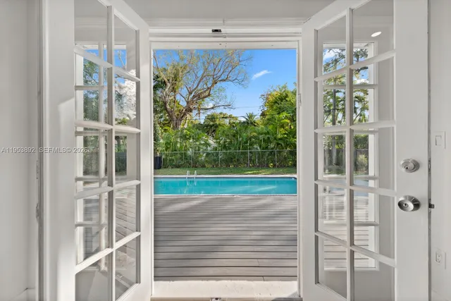 a view of a porch with a floor to ceiling window and plants