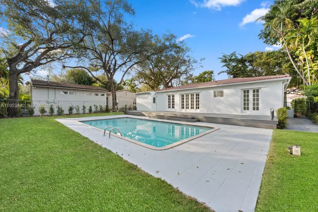 a view of house with outdoor space and swimming pool