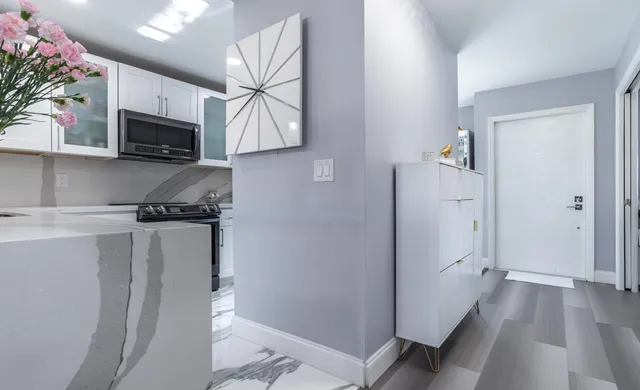 a kitchen with stainless steel appliances a refrigerator sink and microwave