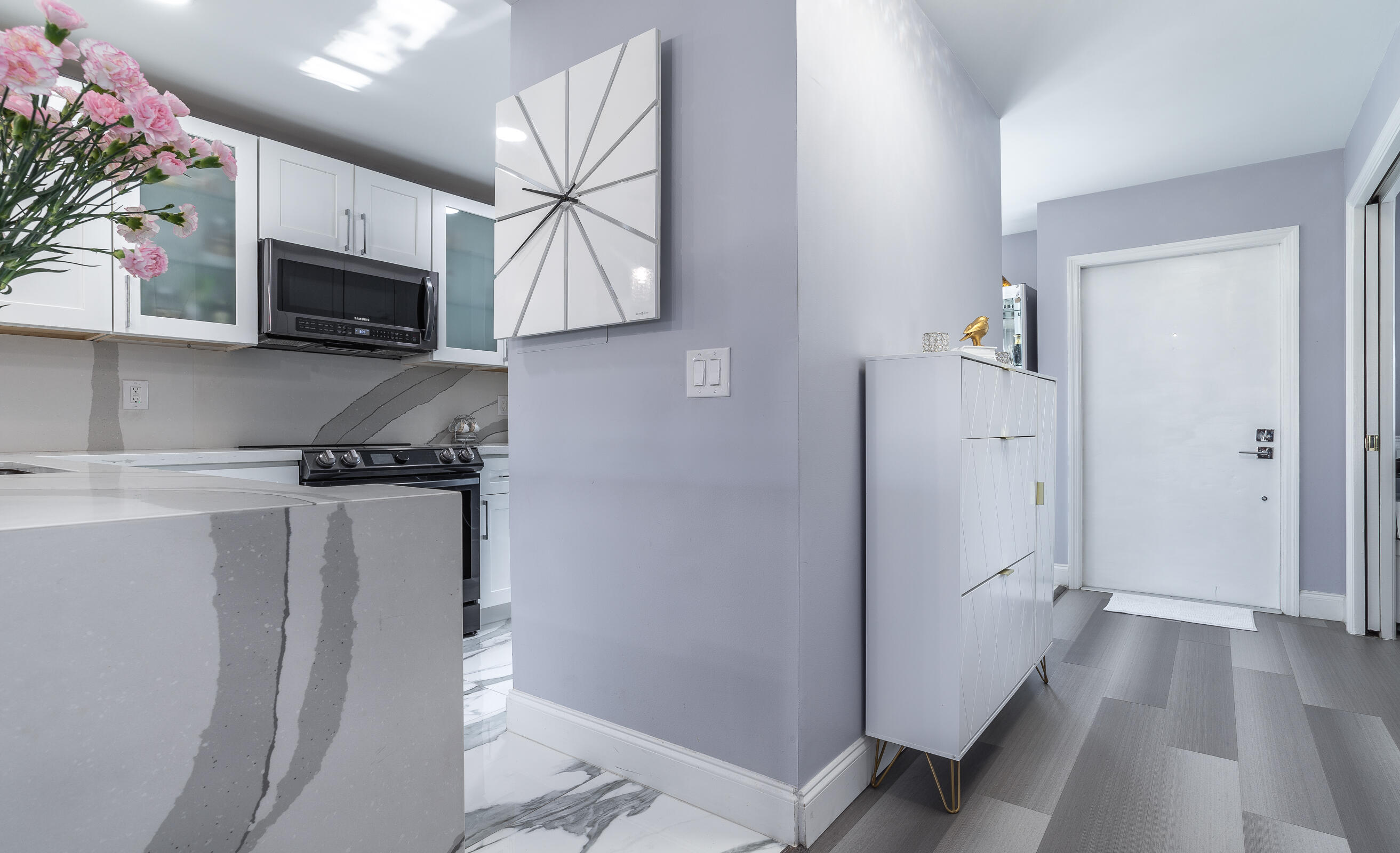 2915 Southwest 15th Street, Unit 203 Delray Beach, FL 33445 - Photo 16 of 48 a kitchen with stainless steel appliances a refrigerator sink and microwave