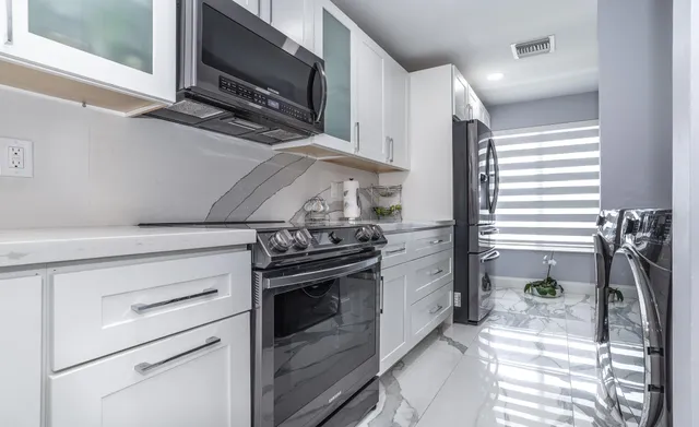 a kitchen with a stove and a microwave
