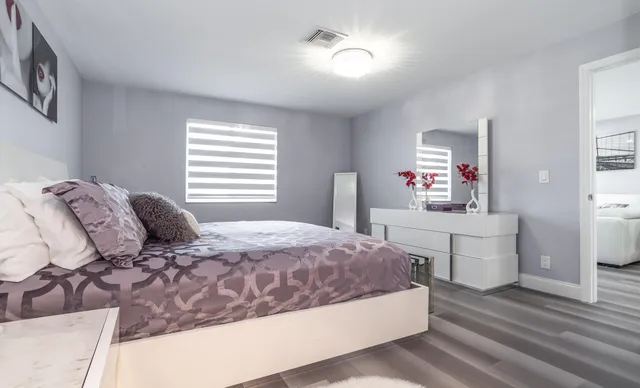 a bedroom with a large bed and a dresser