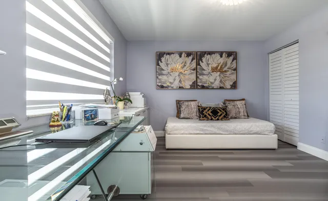 a bedroom with a bed and a large window