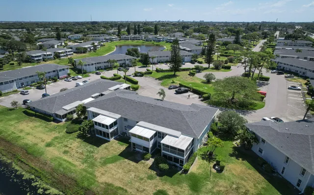 an aerial view of a house with a yard basket ball court and outdoor seating