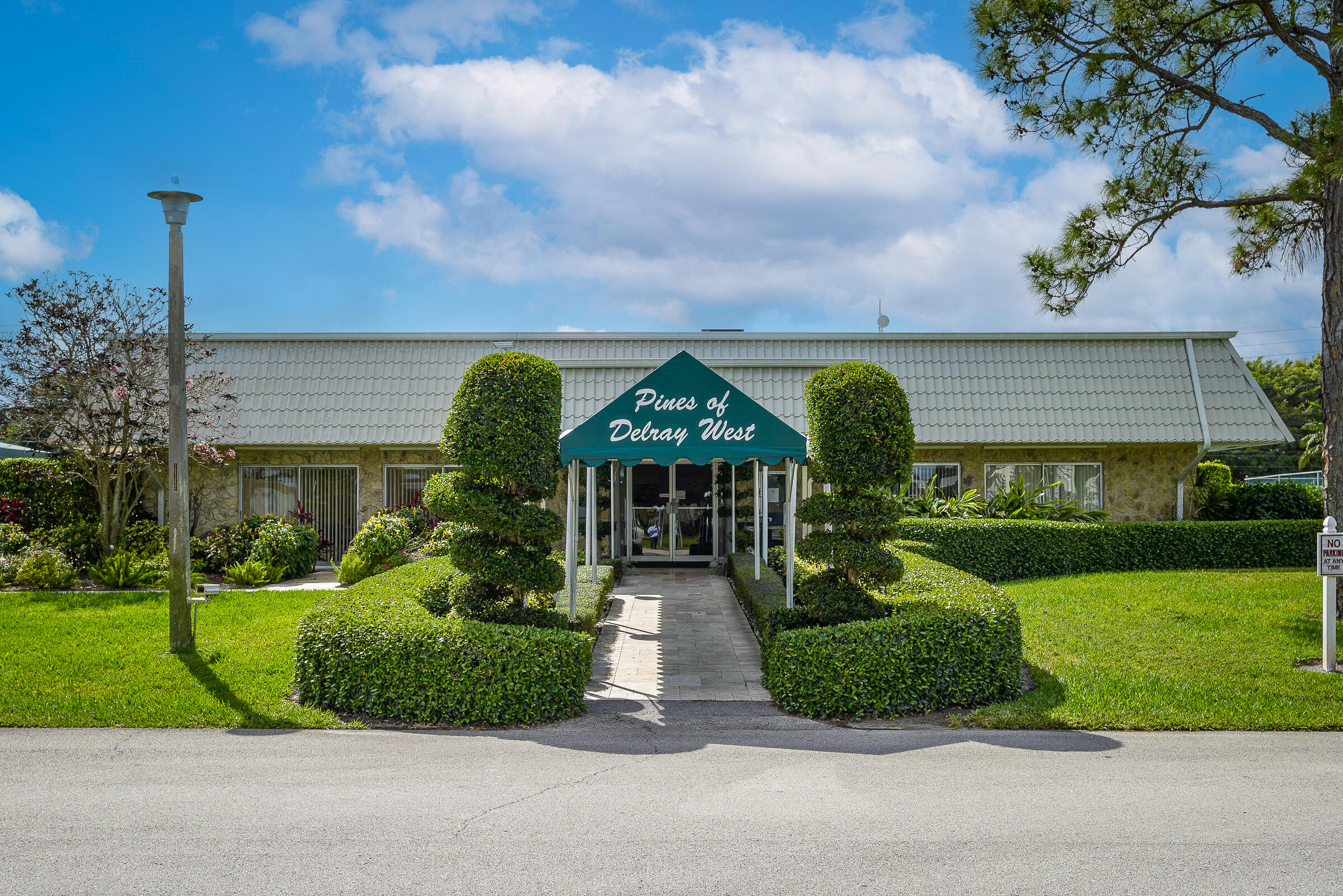 2915 Southwest 15th Street, Unit 203 Delray Beach, FL 33445 - Photo 34 of 48 a front view of house with yard and green space