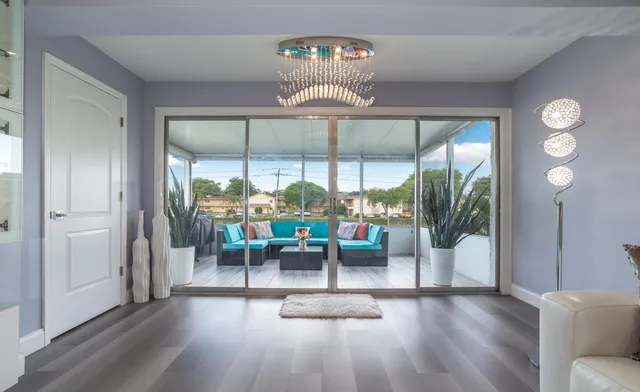 a view of a dining room with furniture wooden floor and chandelier