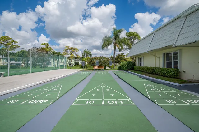 a view of a pathway of a house with a yard