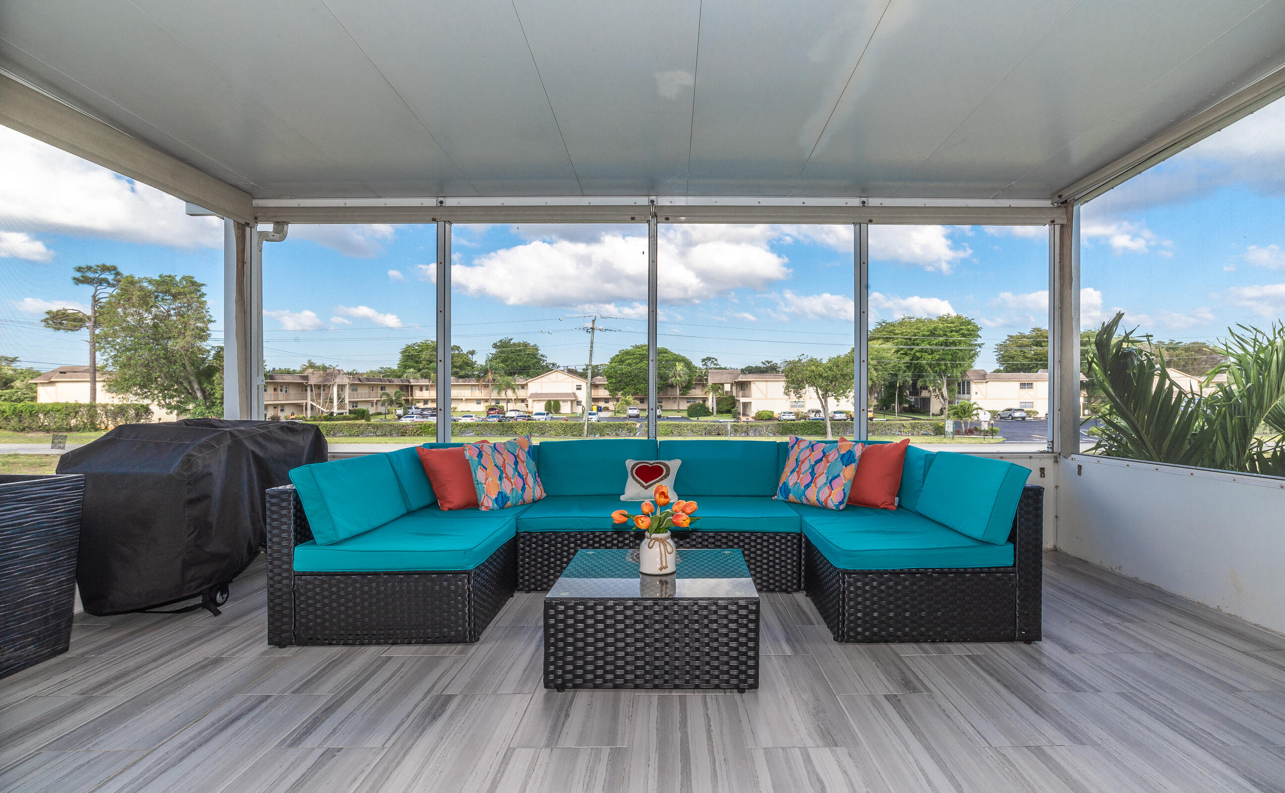 2915 Southwest 15th Street, Unit 203 Delray Beach, FL 33445 - Photo 5 of 48 a living room with furniture city view and large windows
