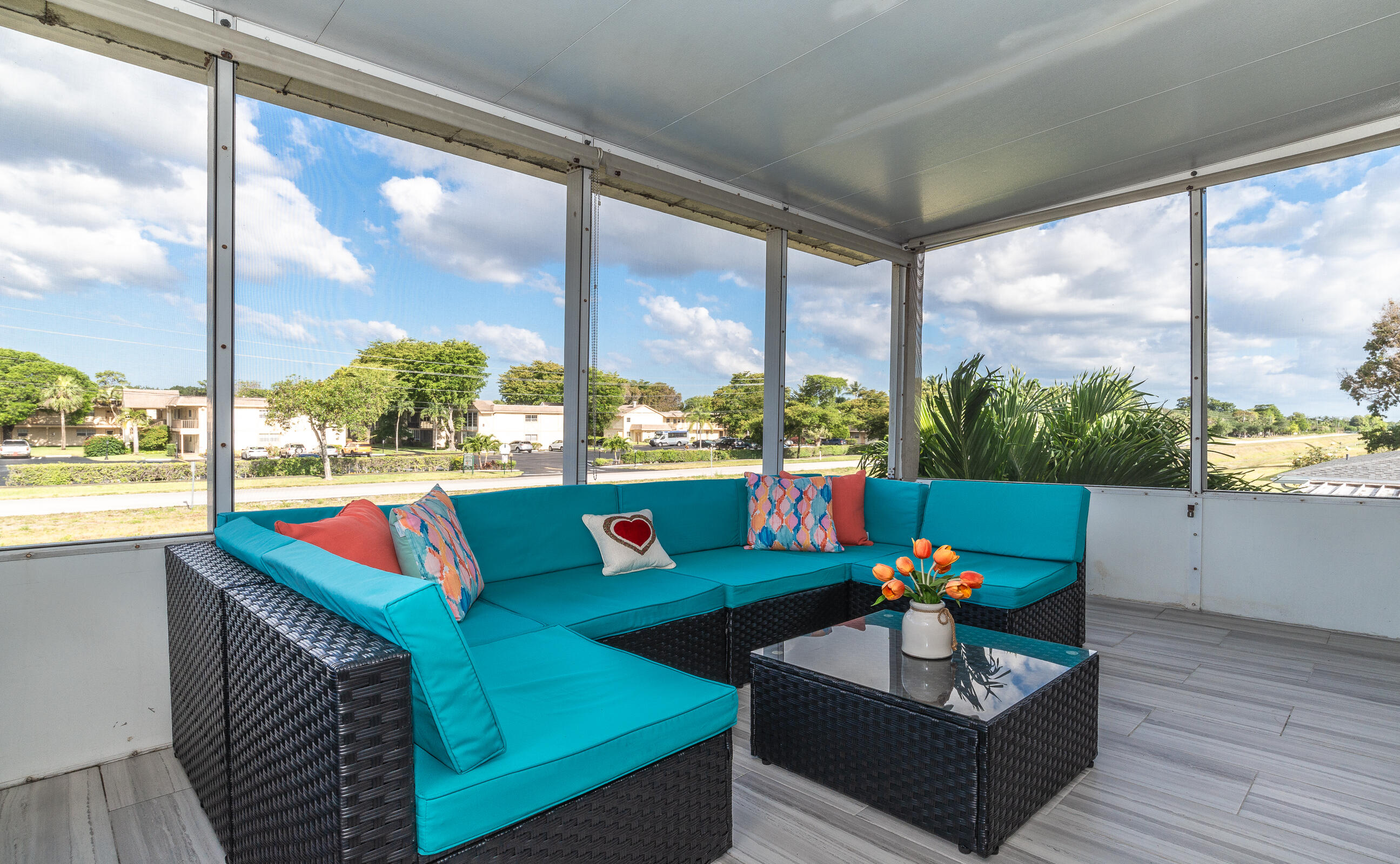 2915 Southwest 15th Street, Unit 203 Delray Beach, FL 33445 - Photo 7 of 48 a living room filled with furniture and a floor to ceiling window