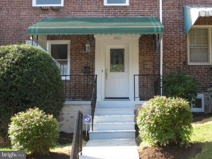 1011 Andover Road Baltimore, MD 21218 - Photo 2 of 29 a front view of a house with a garden
