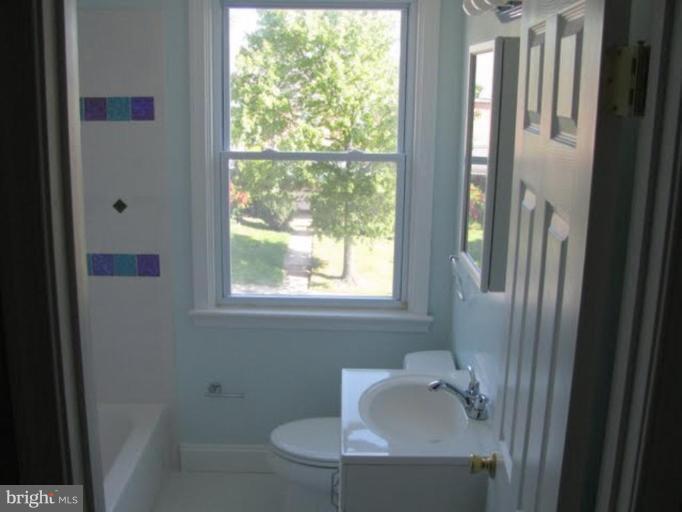 1011 Andover Road Baltimore, MD 21218 - Photo 17 of 29 a bathroom with a sink a toilet and tub