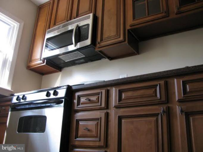 1011 Andover Road Baltimore, MD 21218 - Photo 28 of 29 a kitchen with a stove microwave and sink