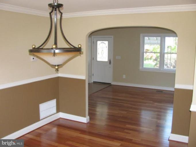 1011 Andover Road Baltimore, MD 21218 - Photo 5 of 29 a view of a room with wooden floor and chandelier