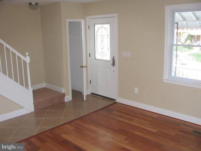 1011 Andover Road Baltimore, MD 21218 - Photo 10 of 29 an empty room with wooden floor and windows
