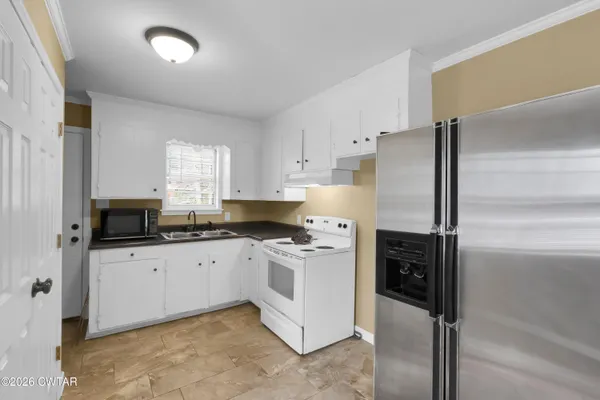 a kitchen with a sink stove and refrigerator